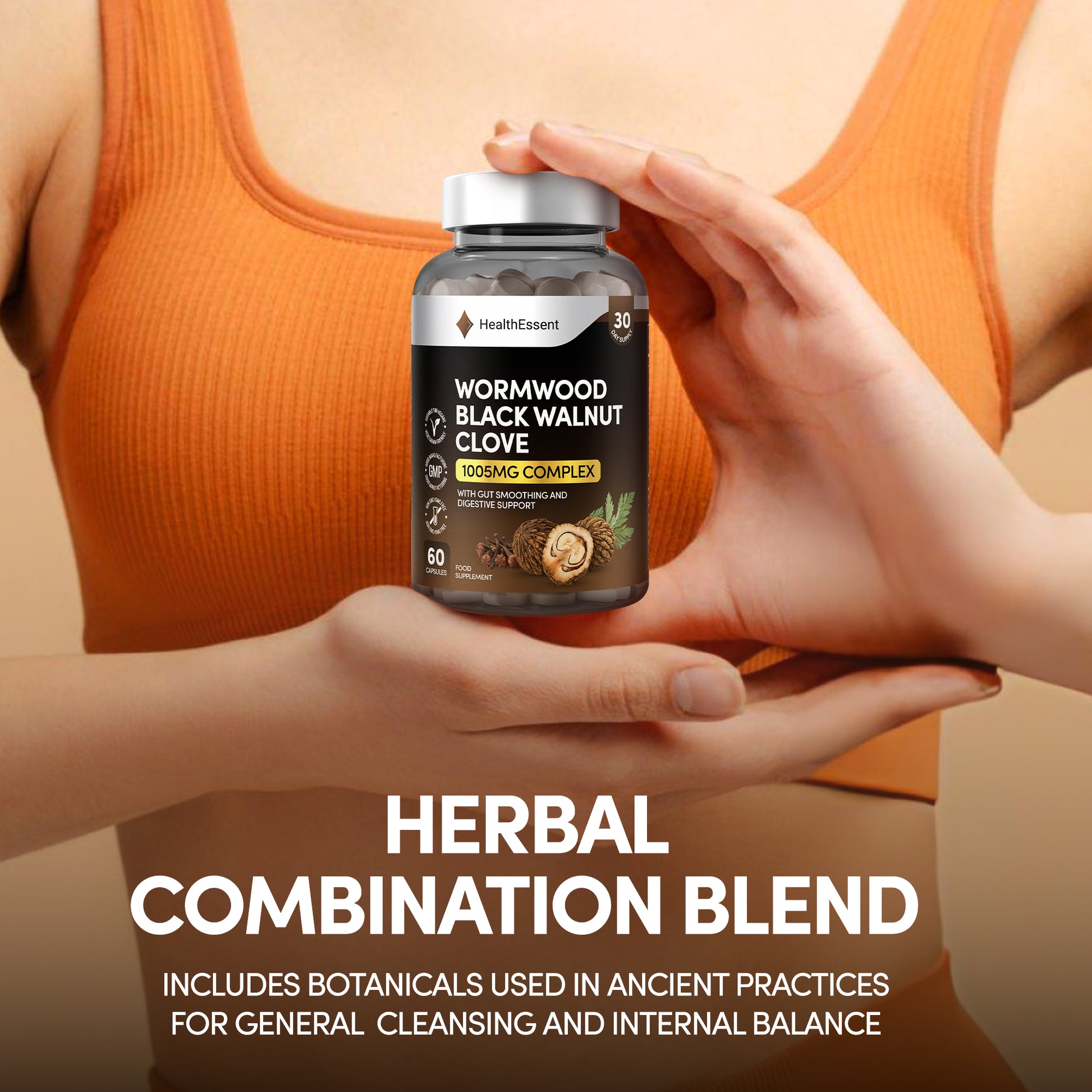 Hands holding HealthEssent Wormwood Black Walnut Clove supplement bottle - traditional herbal formula with added pumpkin seed and papaya seed for complete digestive support
